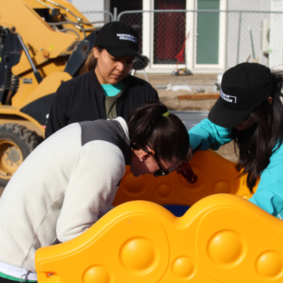 Image of a group of Veterans assembling a large playground structure