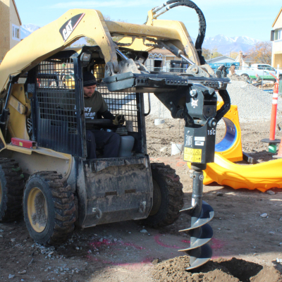 Image of a man operating a large hole drilling machine