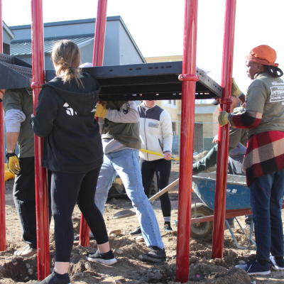 Image of a group of Veterans assembling a large playground structure