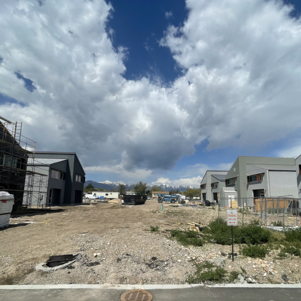 Picture of a dirt lot surrounded by houses. 